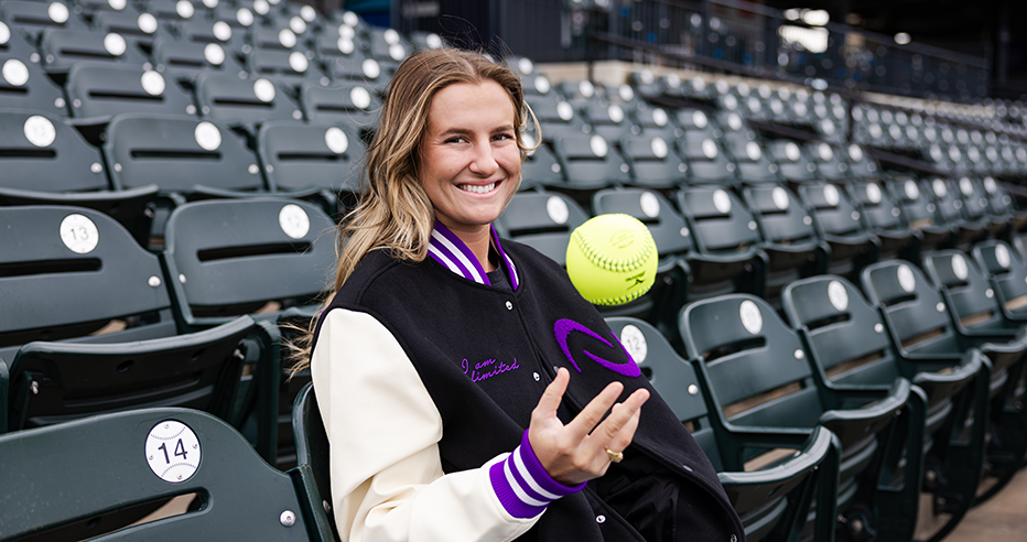 Texas Softball star Reese Atwood signed an NIL deal with the AUSL. In the photo, she wears an AUSL jacket and smiles as she tosses a softball into the air.