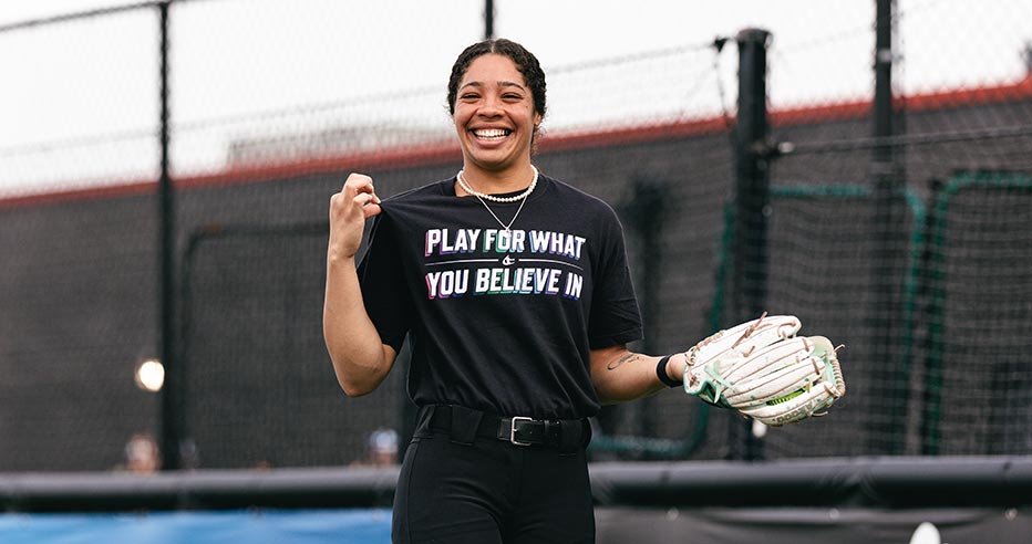 Aliyah Binford smiles while wearing a "Play for What you Believe in" t-shirt.